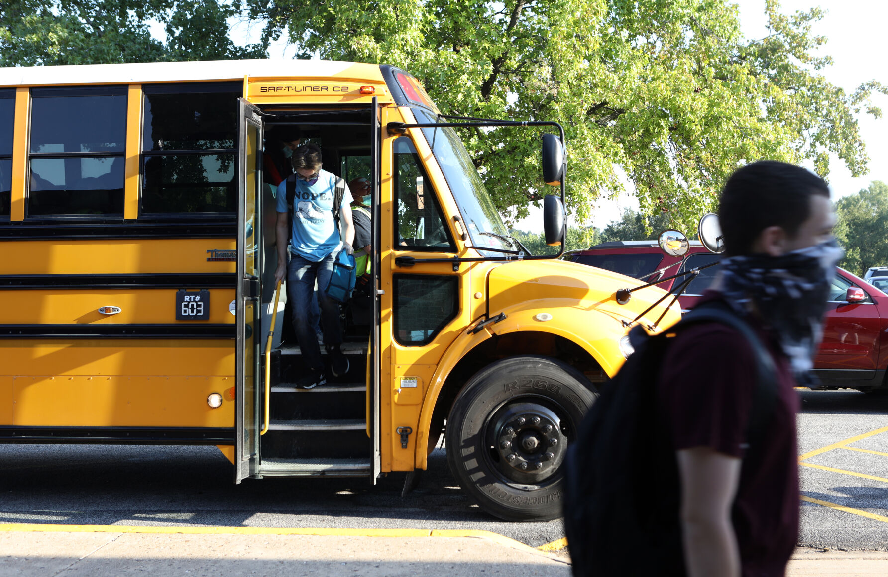 Students climb off the bus
